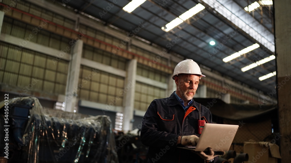Factory engineer or foreman worker maintaining check equipment parts in factory. Factory engineer or foreman worker maintaining check equipment parts in factory.