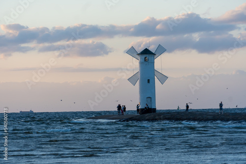 Windmill on the coast at sunset in Świnoujście. Poland, See, Sommer 2022