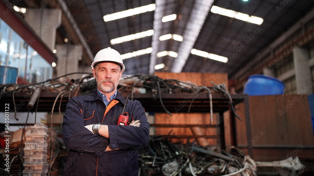 Man engineer standing on construction site or equipment maintenance work site.