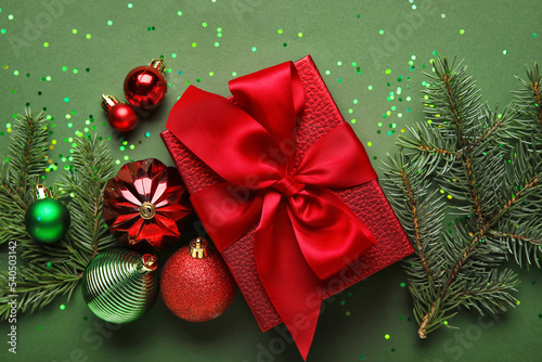 Composition with Christmas gift  decorations and fir branches on color background  closeup