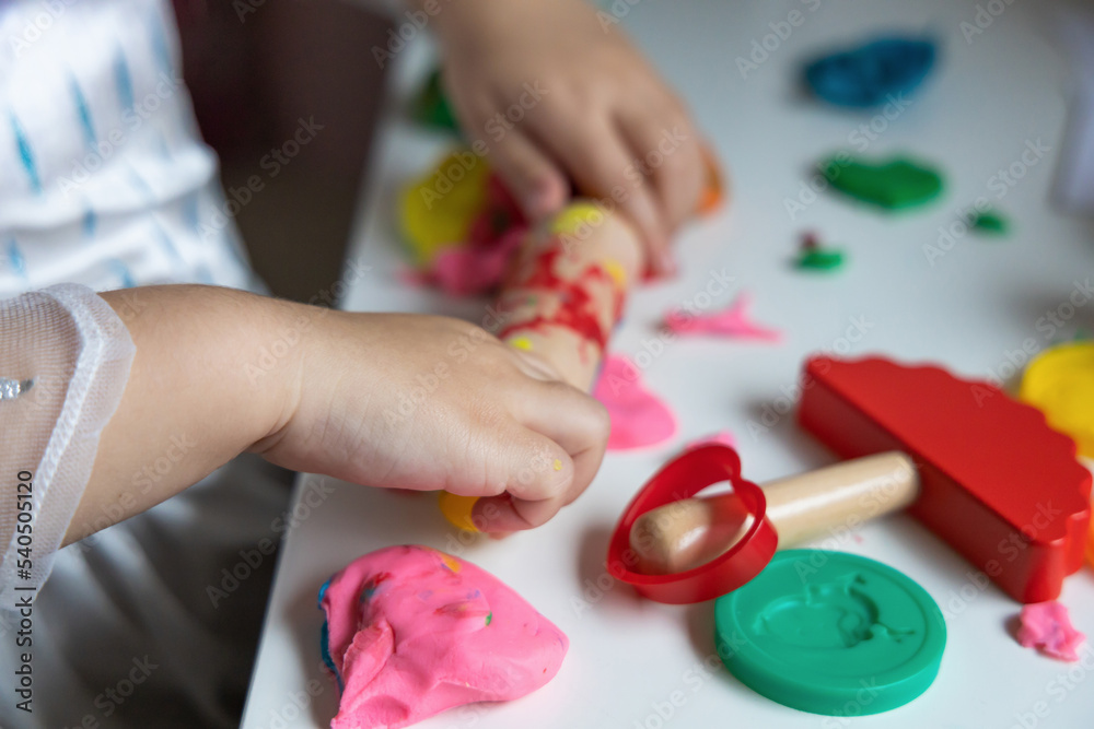 Child development and children's creativity. The child is engaged in modeling plasticine. Child development and children's creativity. The child is engaged in modeling plasticine.