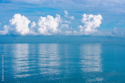 The front view in the morning sky is bright blue with clear white clouds. And the ocean deep indigo in daylight. Feeling calm  cool  relaxing. The idea for cold background and copy space on the top.