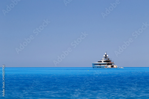 White yacht anchored in fantastic Myrtos Beach turquoise and blue bay. Summer scenery of famous and extremely popular travel destination in Cephalonia island, Greece, Europe. © Iryna Budanova
