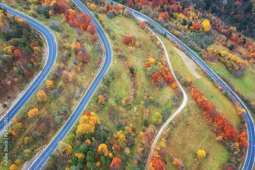 Scenic aerial view of the colorful autumn wooded mountains and mountain pass,...