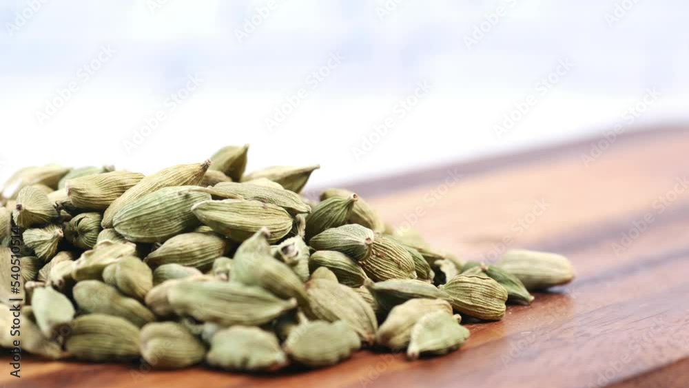 close up of Cardamom on a chopping board on table close up of Cardamom on a chopping board on table