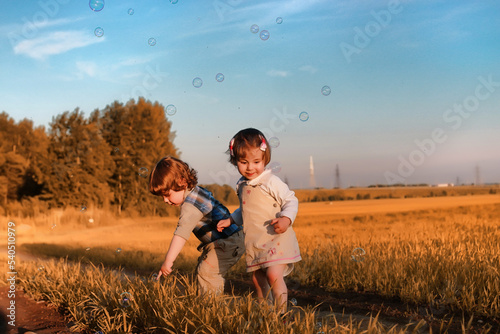 Children outdoors in a field © alexkich