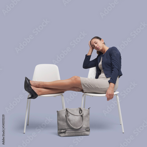 Businesswoman falling asleep on a chair