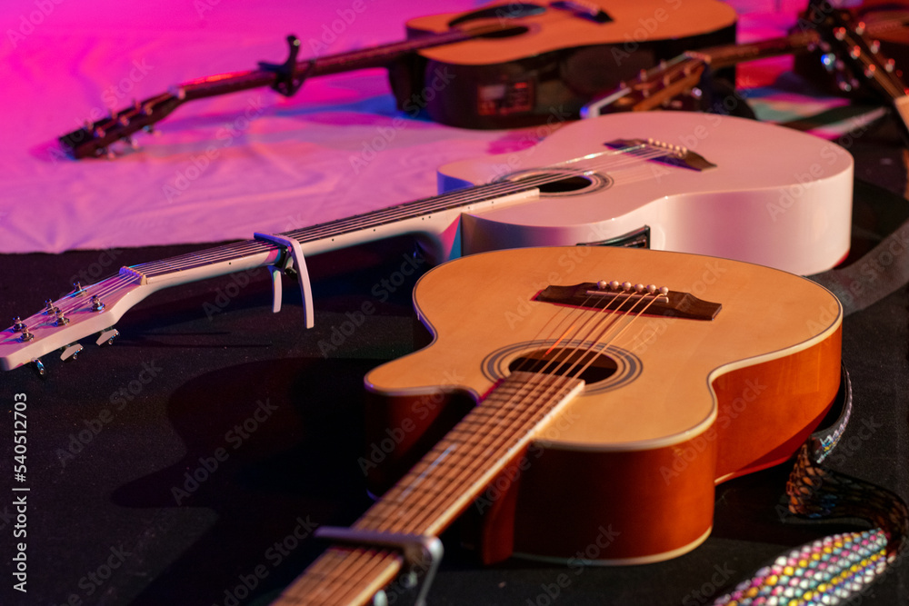 Fototapeta premium Three guitars arranged in a stage setting before the concert