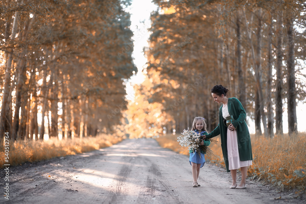 Mother with daughter walking on a road Mother with daughter walking on a road