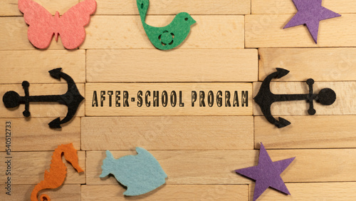 Wooden man holding frame. After school program writing. Background is white. Education and work