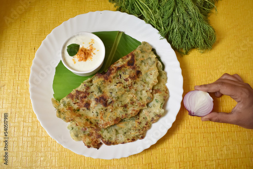 A Selective focus Picture of Karnataka's favorite Delicacy called Akki Rotti on a table