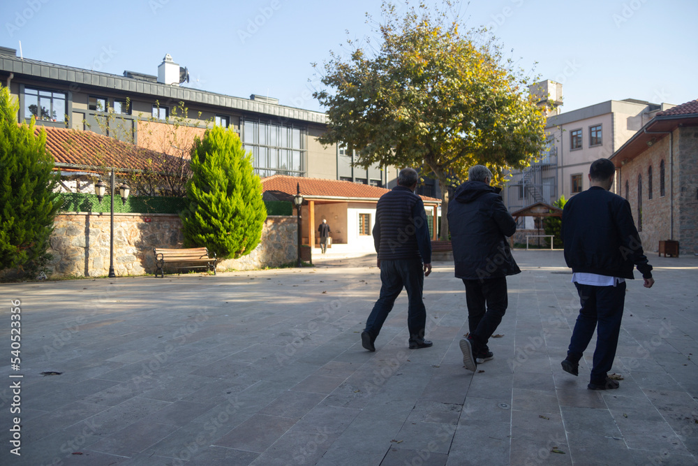 Three men walking side by side in Istanbul, turkey Three men walking side by side in Istanbul, turkey