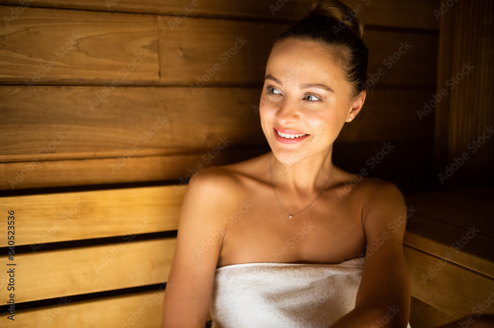 Woman relaxing in a sauna Woman relaxing in a sauna