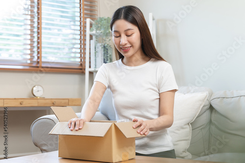 person unboxing package shopping online via internet at home