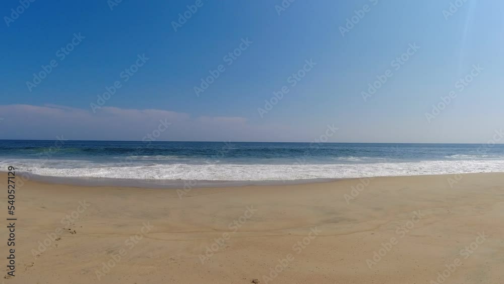 The waves break calmly on a beautiful deserted beach on the Pacific coast of Mexico The waves break calmly on a beautiful deserted beach on the Pacific coast of Mexico