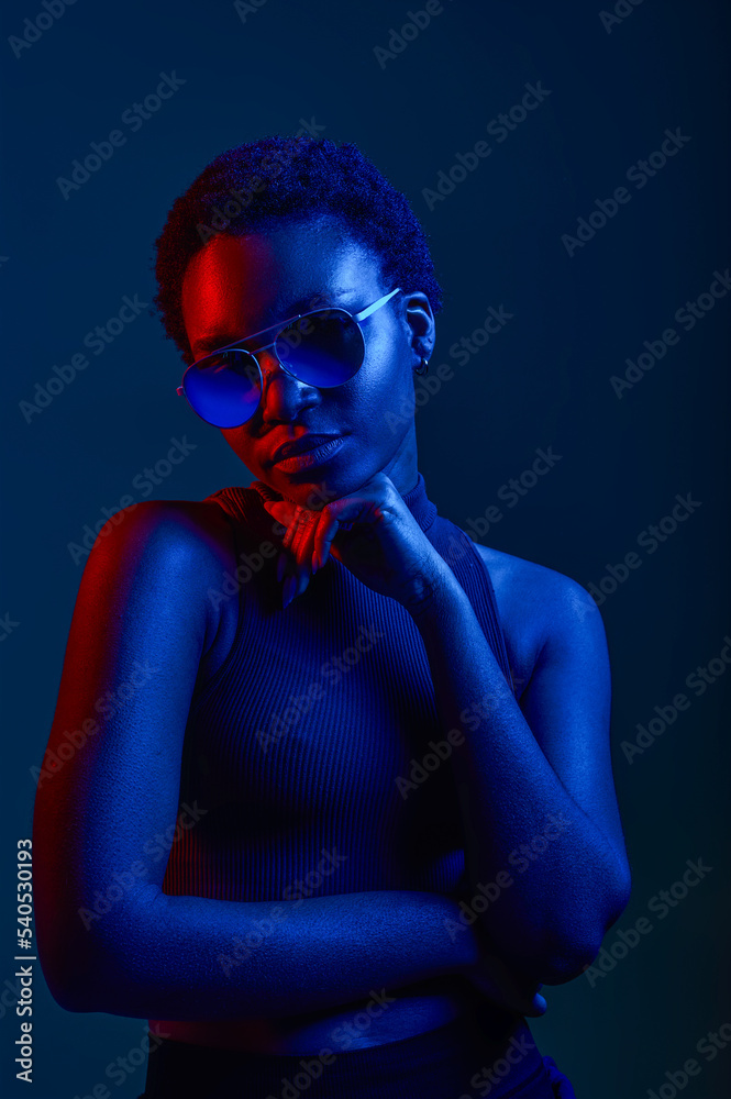 Pensive woman in sunglasses over dark background Pensive woman in sunglasses over dark background