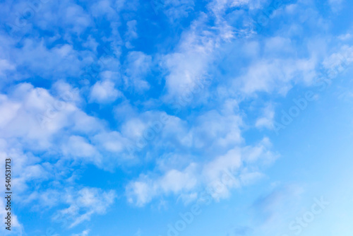 White curly clouds on the blue sky