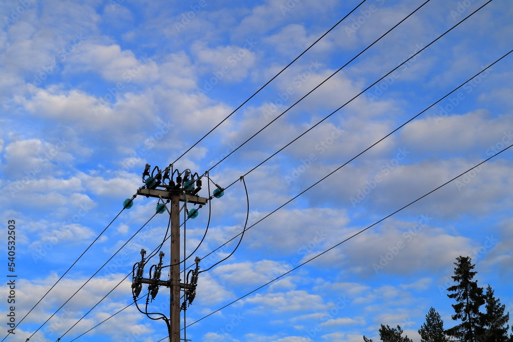 20kV current power lines. Wooden pole. Sky in the background. Stockholm, Sweden. 20kV current power lines. Wooden pole. Sky in the background. Stockholm, Sweden.