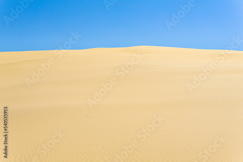 desert landscape, sand dunes under blue sky