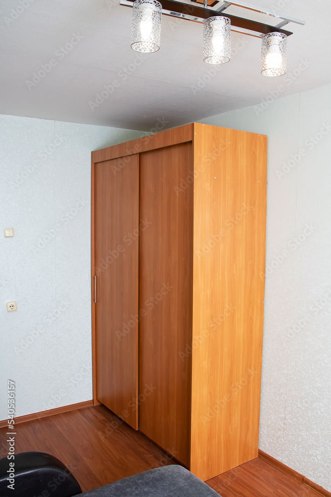 Fototapeta premium Wardrobe with sliding doors in the room