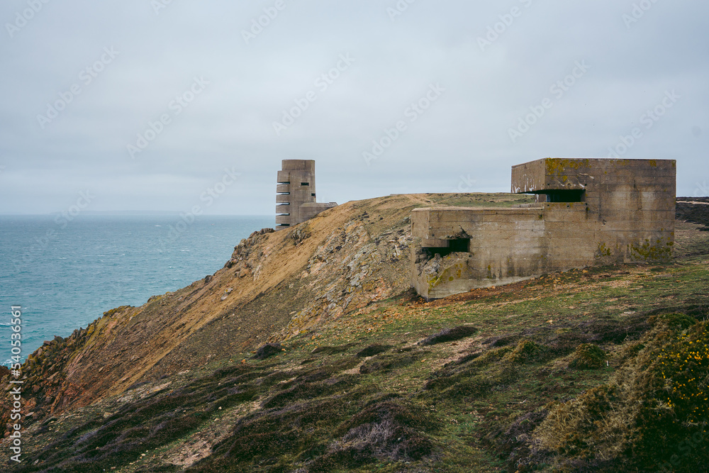 Abandoned World War II bunker on the cliffs of the island on cloudy day