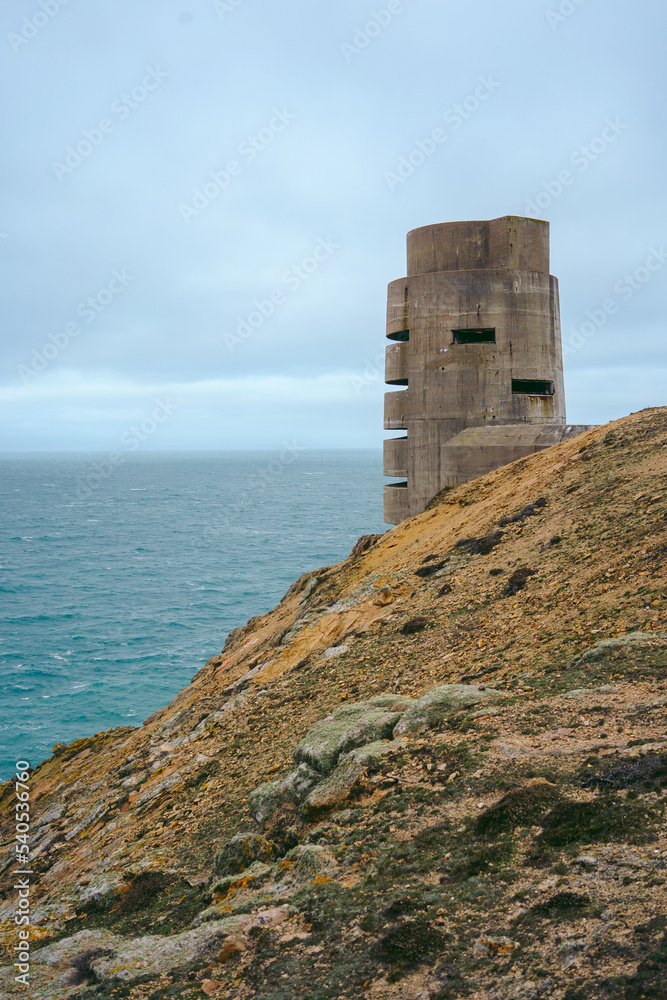 Abandoned World War II bunker on the cliffs of the island on cloudy day