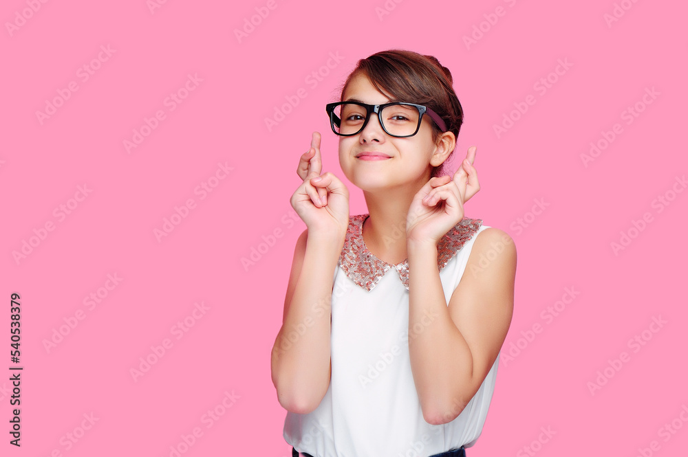 Little girl crosses fingers to fulfill her dreams