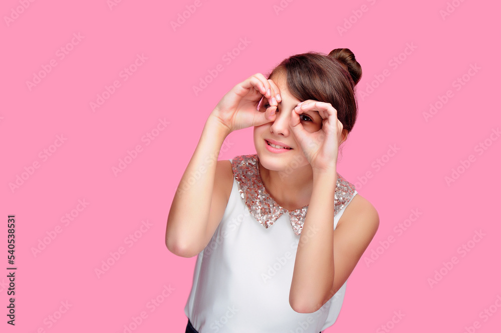 School girl making binoculars with her hands School girl making binoculars with her hands