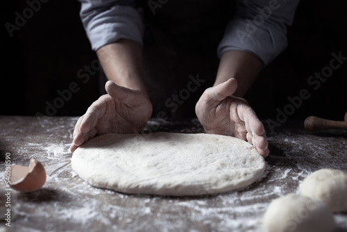 Chef man kneading dough bread or pizza for homemade cooking at table