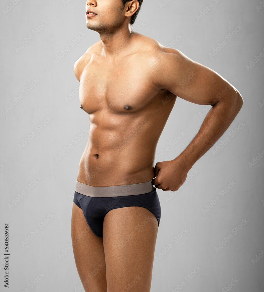 Cropped shot of muscular young man wearing underwear isolated on white background. Cropped shot of muscular young man wearing underwear isolated on white background.