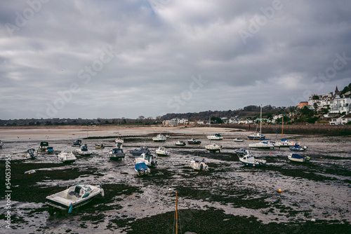 Boats moored at the seaside on cloudy day