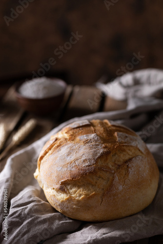 Fresh bread and table cloth on wooden table. Bakery still life and bread at wood tabletop