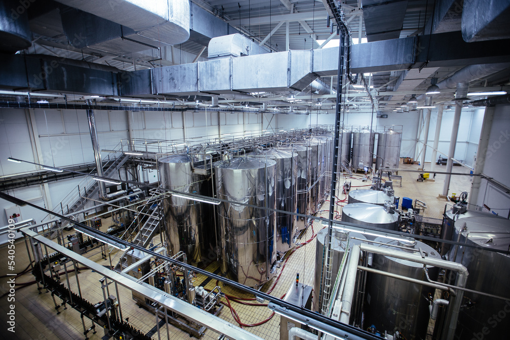 Modern winery production line. Storage vats and bottling equipment