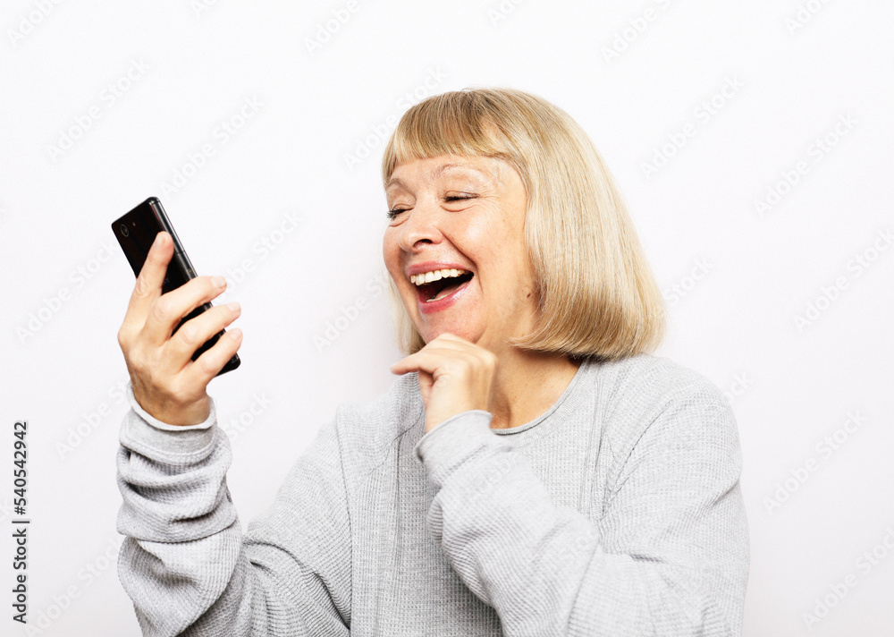 Old woman watching funny videos on internet. Old woman watching funny videos on internet.