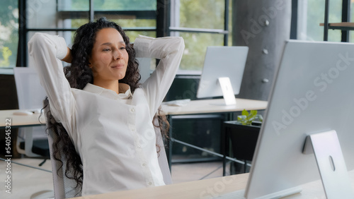 Wallpaper Mural Relaxed contented young woman sitting at workplace enjoying finished work happy calm businesswoman leaning back in chair holding hands behind head relaxing resting daydreaming taking break at office Torontodigital.ca
