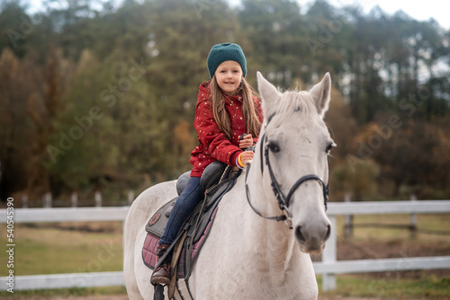 girl is riding a white horse 
