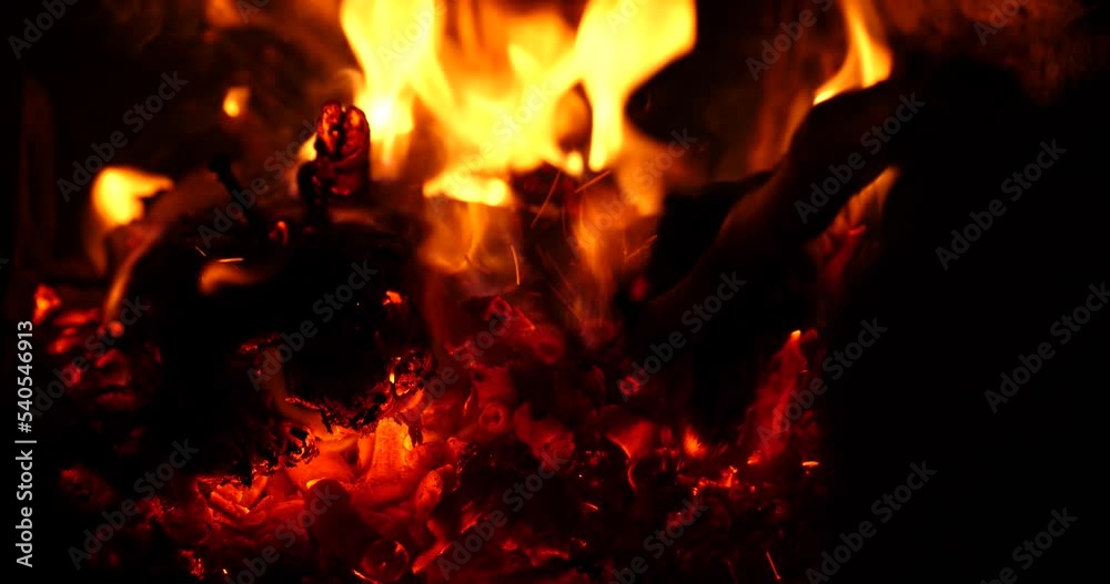 heat from the burning fire, hand, straightens the red coals with a stick in the oven. High quality 4k footage heat from the burning fire, hand, straightens the red coals with a stick in the oven. High quality 4k footage
