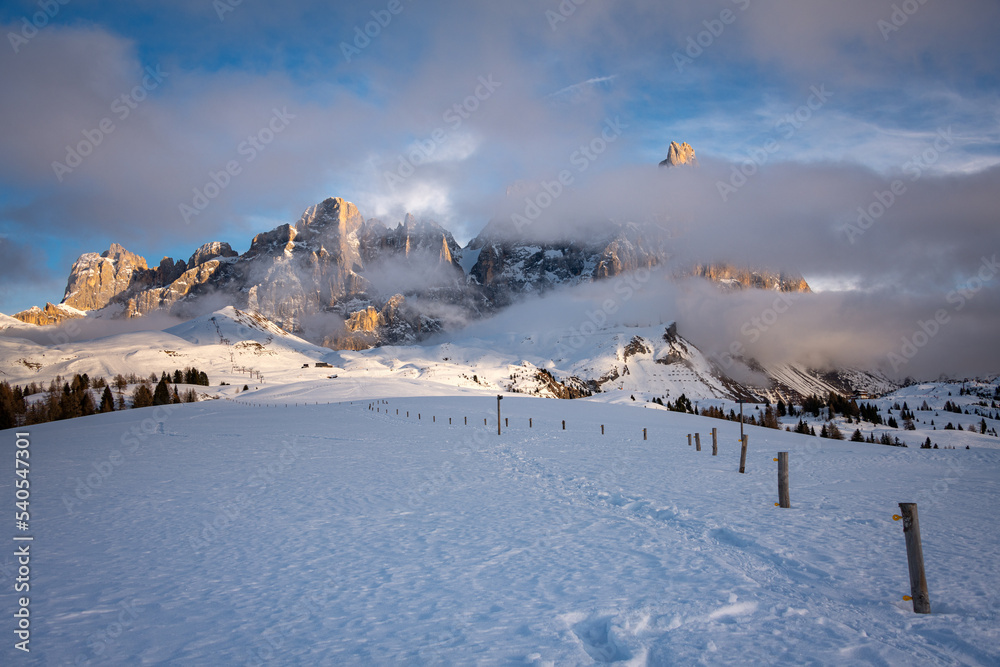 aerial view of Pale di San Martino and Passo Rolle covered with snow in winter, Italy