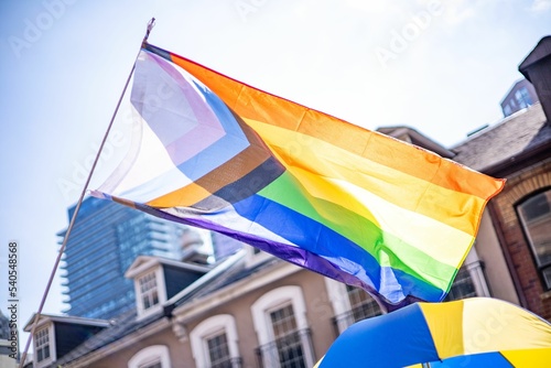Photography Waving pride flag against buildings in Toronto on a sunny day