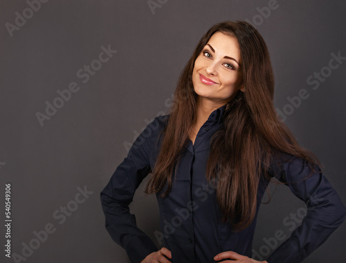 Beautiful confident calm thinking smiling business woman satnding in power pose in blue shirt on grey background with empty copy space for text. Closeup