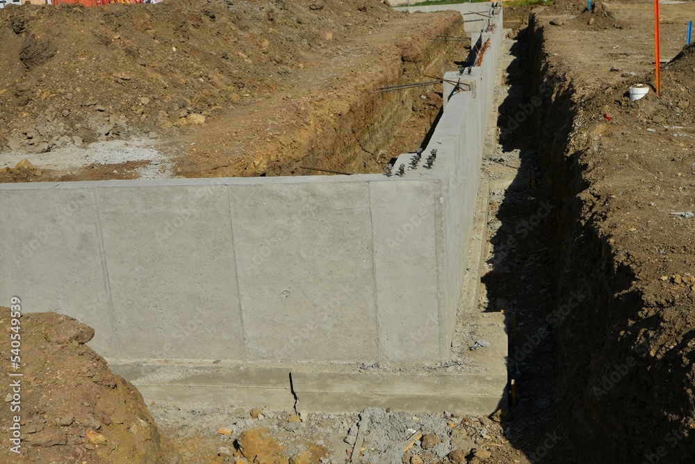 Concrete footings and foundation with anchor bolts ready for more