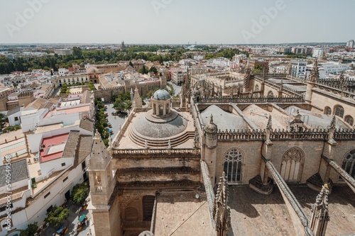 Aerial shot of the architecture of the Catedral de Sevilla in Spain against a blue sky photo