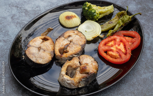 Acorn slices in a black plate ; Bonito fish grill