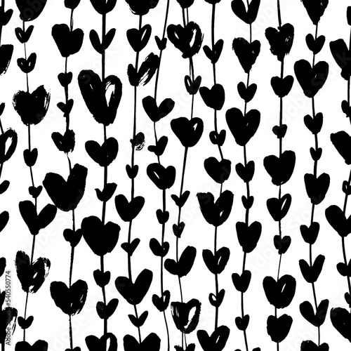 Black silhouettes heart ivy seamless pattern. Brush drawn liana or garland with heart symbols. Thin long vertical branches with leaves ornament. Vector ink illustration for wedding and love holidays. 