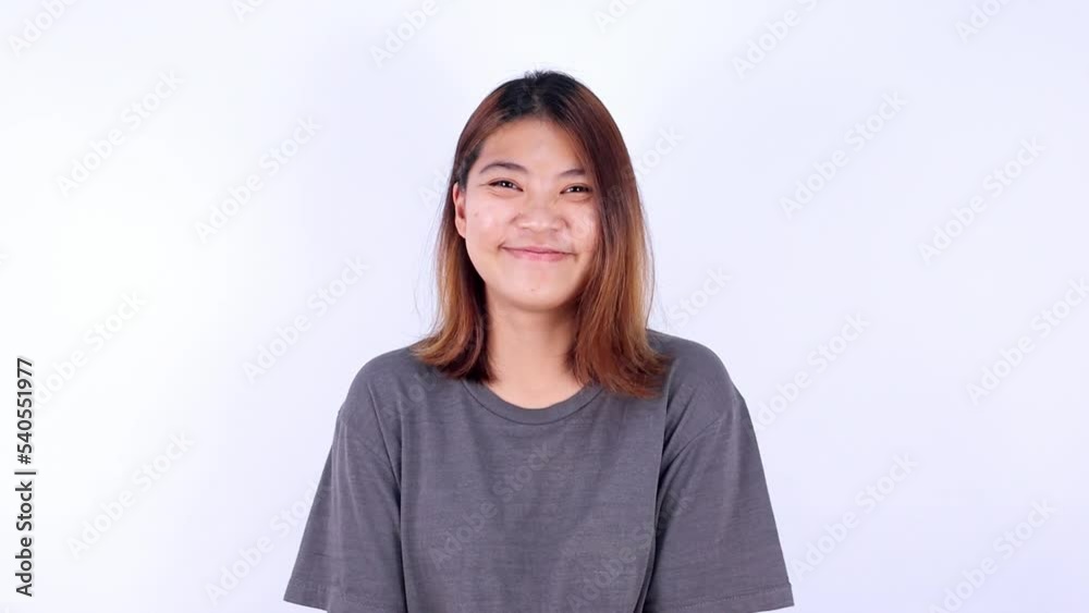 Young Asian woman looks at the camera and smiles happily, cute and cheerful. Young Asian woman looks at the camera and smiles happily, cute and cheerful.