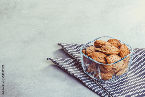 Bowl with almonds in shell copy space.