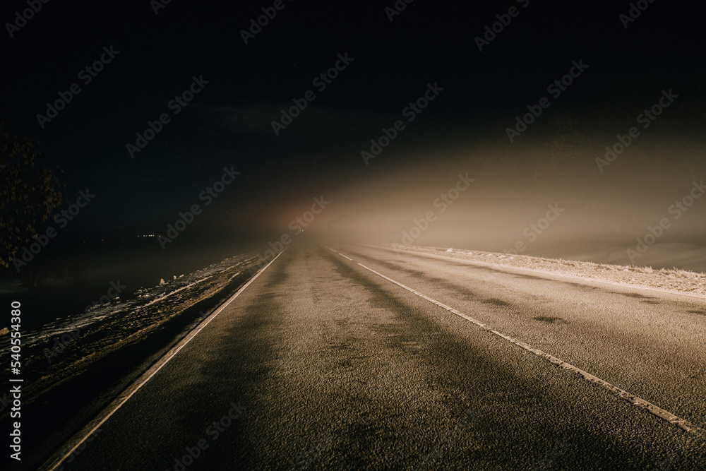 Foggy misty road at night