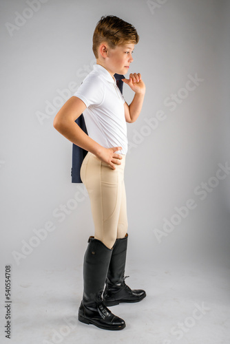 Child Youth Boy Equestrian Rider Posing with Jacket Over His Shoulder photo