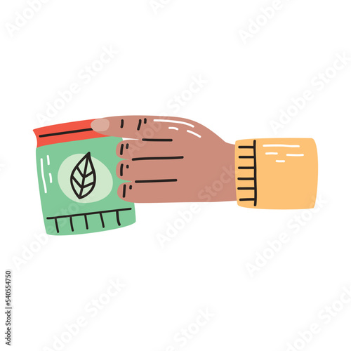 hand with gardening seeds bag