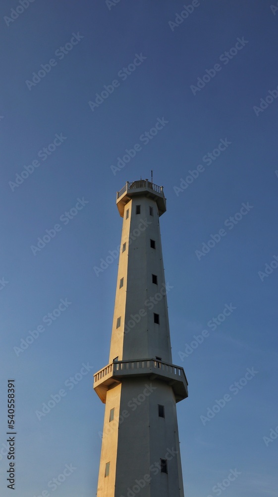 lighthouse in the fisherman village with blue sky